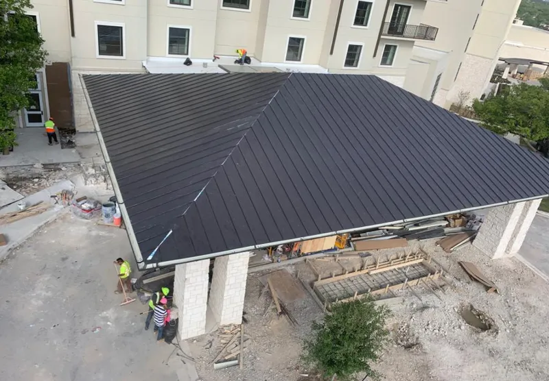 Metal roofing installation team working on a commercial building in Keystone