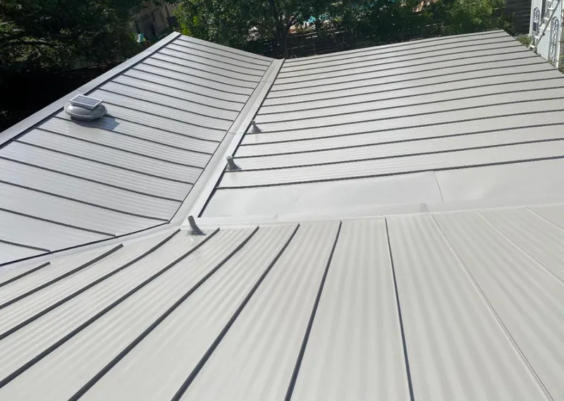 Solar attic fan installed on a metal roof for Roof Ventilation in Keystone